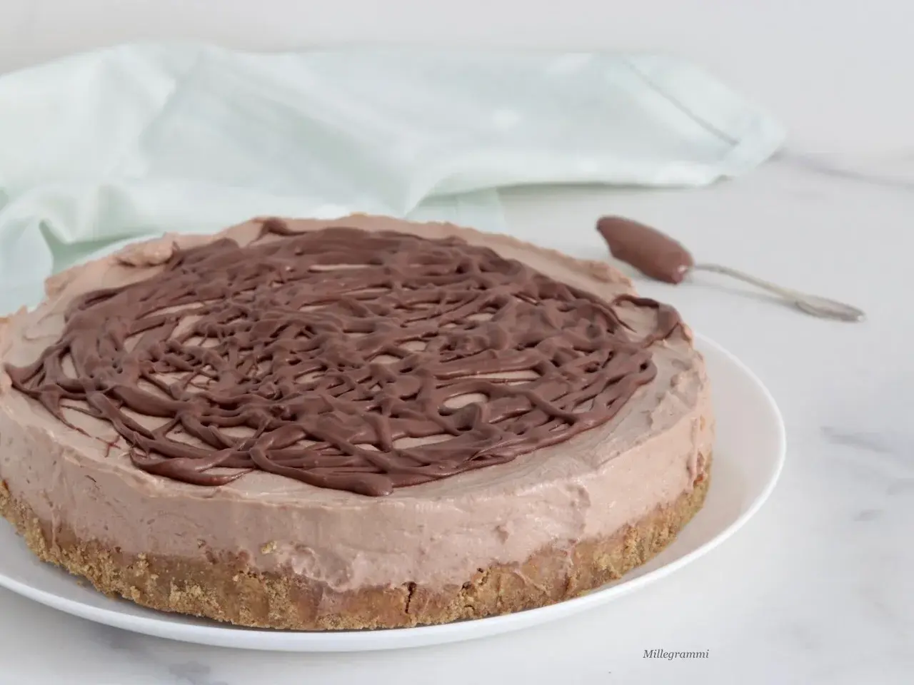 Deliziosa cheesecake alla Nutella con copertura a spirale di cioccolato, pronta per essere gustata.